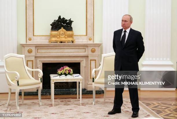 Russian President Vladimir Putin stands in a hall prior to a meeting with his Belarus' counterpart at the Kremlin in Moscow on March 11, 2022.
