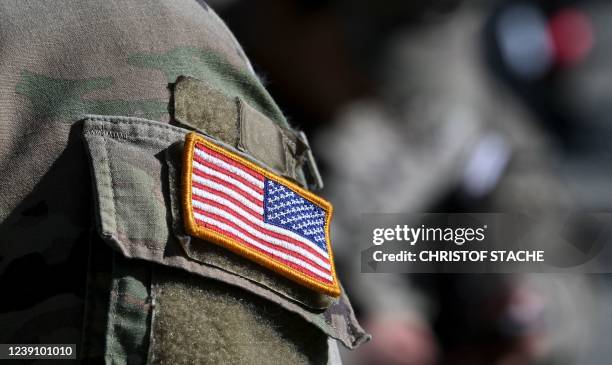 Flag is pictured on a soldier's uniform at the United States Army military training base in Grafenwoehr, southern Germany, on March 11, 2022.