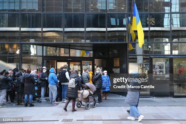 Ukrainian refugees, fleeing the war in their country invaded by Russians, lined up in front of the Ukrainian Consulate in Naples, waiting to receive...