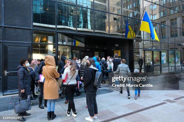 Ukrainian refugees, fleeing the war in their country invaded by Russians, lined up in front of the Ukrainian Consulate in Naples, waiting to receive...