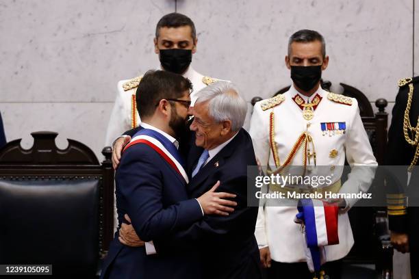 New President of Chile Gabriel Boric embraces Outgoing President of Chile Sebastián Piñera during the presidential inauguration ceremony at the...