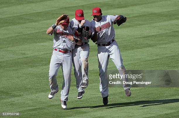 Outfielders Gerardo Parra, Collin Cowgill and Justin Upton of the Arizona Diamondbacks celebrate their 10-7 victory over the Colorado Rockies at...