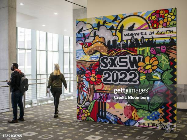 Attendees walk through the Austin Convention Center during South By Southwest festival in Austin, Texas, U.S., on Friday, March 11, 2022. The annual...