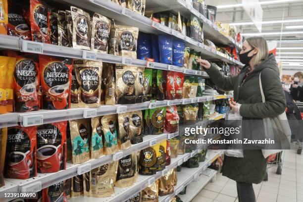 Woman looks at Nescafe coffee packages at a shopping mall, March 2022, in Moscow, Russia. Nestle official said on Friday that the company is...