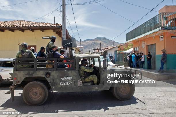 Soldiers patrol teh streets during the funeral of Mayor Cesar Arturo Valencia, in Aguililla, Michoacan state, Mexico, on March 11, 2022. - Gunmen on...