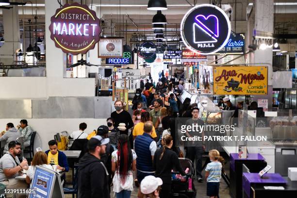 Customers browse food stalls inside Grand Central Market on March 11, 2022 in downtown Los Angeles, California. - US consumer prices hit a new...