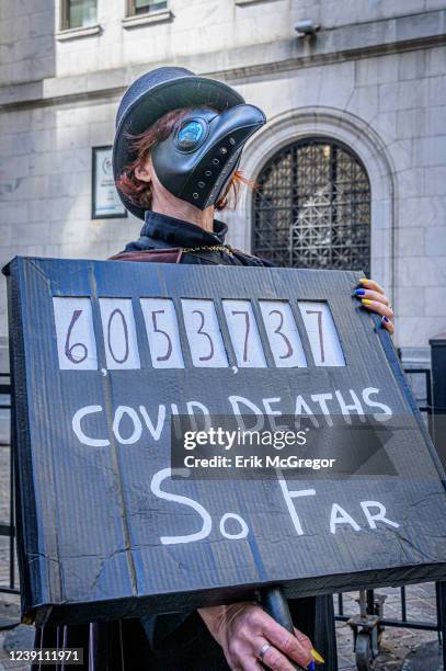 Members of a coalition of healthcare advocacy Participant seen holding a sign at the protest. Community organizations in New York gathered outside...