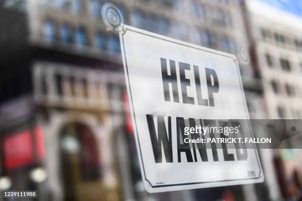 Help wanted sign is displayed in the window of a fast food restaurant on March 11, 2022 in downtown Los Angeles, California. - US consumer prices hit...