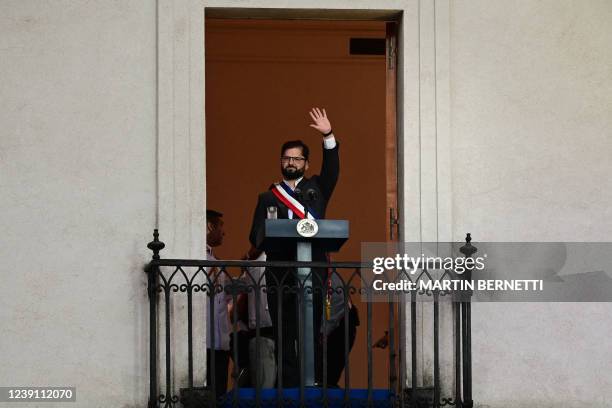 Chile's new President Gabriel Boric greets his supporters before delivering a speech at La Moneda Palace in Santiago, on March 11, 2022. - Leftist...