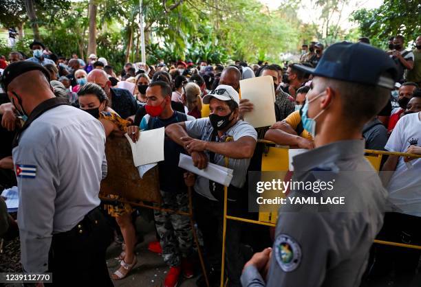 People wait outside the Panamanian Embassy in Havana on March 11, 2022. - The Panamanian government decided to postpone until March 15 the imposition...