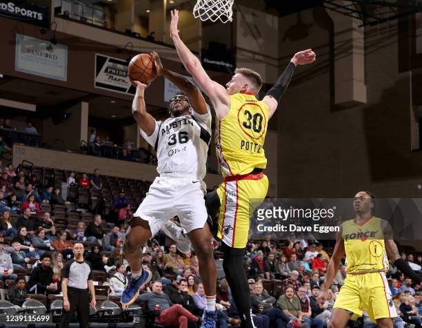 March 11: Denzel Mahoney of the Austin Spurs shoots past Micah Potter of the Sioux Falls Skyforce at the Sanford Pentagon on March 11, 2022 in Sioux...
