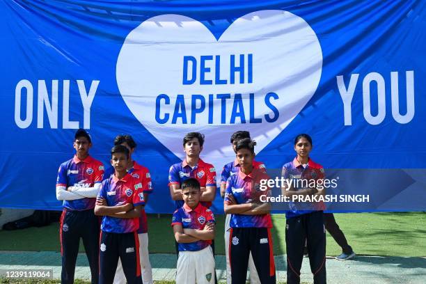 Trainee cricket players from Prestige Warriors, a non-governmental organisation providing free cricket coaching to underprivileged children, pose...