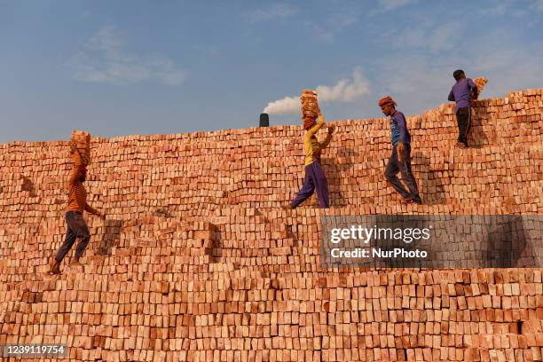 Workers are working at a brickyard in Dhaka, Bangladesh.