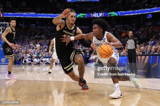 Kentucky Wildcats guard Sahvir Wheeler drives past Vanderbilt Commodores forward Myles Stute during the SEC Tournament between the Vanderbilt...