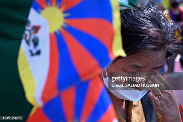 Tibetan living in exile takes part in a peace march to observe the 63rd Tibetan women's uprising anniversary in New Delhi on March 12, 2022.