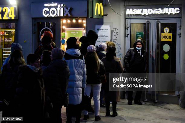 People wait in line to enter a McDonald's restaurant in Moscow. McDonald announced that they are temporarily closing its 850 restaurants in Russia,...