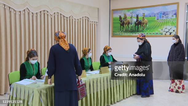 Woman casts her vote during presidential elections in Ashgabat, Turkmenistan on March 12, 2022.