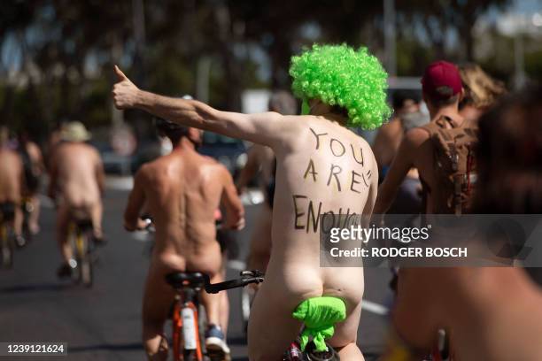 Graphic content / A man gives thumb up as he joins others cycling through the city during the annual World Naked Bike Ride, on March 12 in Cape Town....