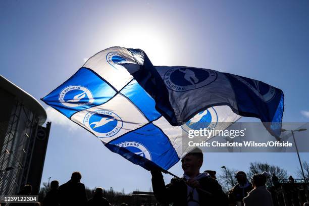 Young Brighton fan waves a homemade Brighton & Hove Albion flag made from 9 small flags stitched together ahead of the Premier League match between...