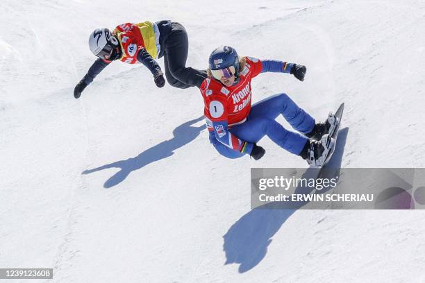 Britain's Charlotte Bankes competes ahead of France's Camille Poulat during the FIS Snowboard Cross World Cup on March 12 at Reiteralm near...