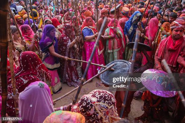 Women hit revellers with sticks as a traditional practice during the Lathmar Holi celebrations, the Hindu spring festival of colours, at Nandgaon...