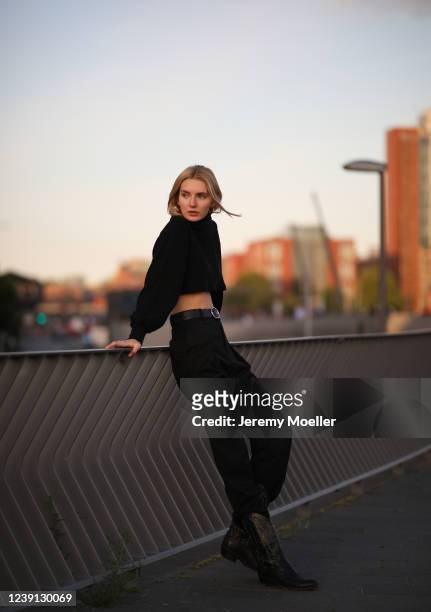 Eva Staudinger wearing H&M Studio pants, vintage cowboy boots and Motel Rocks sweater on May 28, 2020 in Hamburg, Germany.