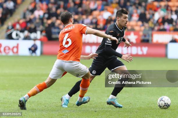 Kevin Stewart of Blackpool challenges Joel Piroe of Swansea City during the Sky Bet Championship match between Blackpool and Swansea City at...