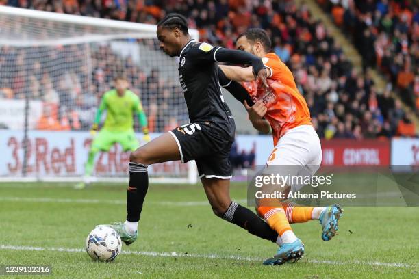 Nathanael Ogbeta of Swansea City challenged by Kevin Stewart of Blackpool during the Sky Bet Championship match between Blackpool and Swansea City at...