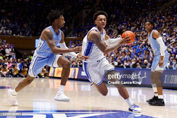 Paolo Banchero of the Duke Blue Devils drives against Leaky Black of the North Carolina Tar Heels at Cameron Indoor Stadium on March 5, 2022 in...