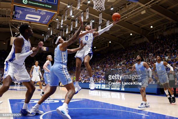 Wendell Moore Jr. #0 of the Duke Blue Devils goes to the basket against Armando Bacot of the North Carolina Tar Heels at Cameron Indoor Stadium on...