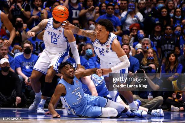 Paolo Banchero of the Duke Blue Devils reaches for the ball against Dontrez Styles of the North Carolina Tar Heels at Cameron Indoor Stadium on March...