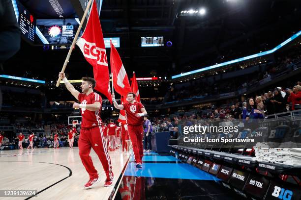 Indiana Hoosiers cheerleaders carry flags during a game against the Iowa Hawkeyes on March 12, 2022 during the Big Ten Tournament at Gainbridge...