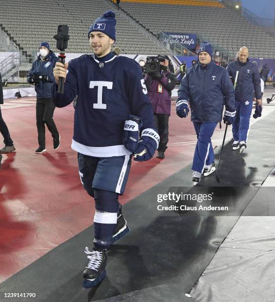 Michael Bunting of the Toronto Maple Leafs does a selfie with coach Sheldon Keefe behind him at practice prior to playing against the Buffalo Sabres...
