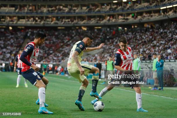Jesús Angulo of Chivas fights for the ball with Diego Valdés of America during the 10th round match between Chivas and America as part of the Torneo...