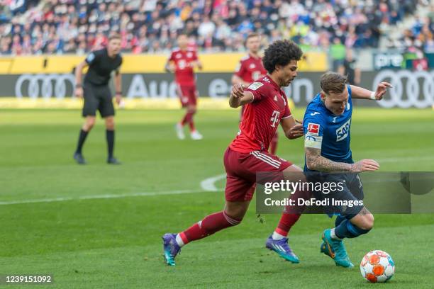 Serge Gnabry of Bayern Muenchen and David Raum of TSG 1899 Hoffenheim battle for the ball during the Bundesliga match between TSG Hoffenheim and FC...