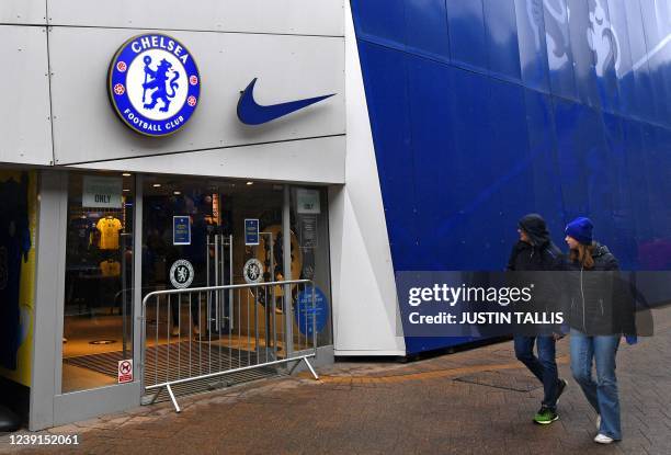 Fans look at a barrier placed across the entrance to the closed merchandise shop at Stamford Bridge, the home ground of Chelsea football club, in...