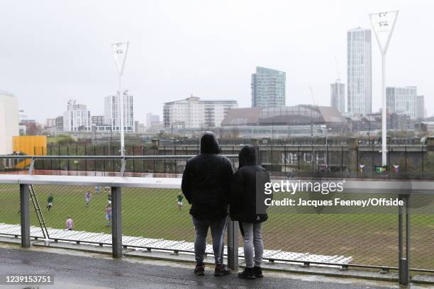 Fans watch a Sunday league match next to the stadium during the Premier League match between West Ham United and Aston Villa at London Stadium on...