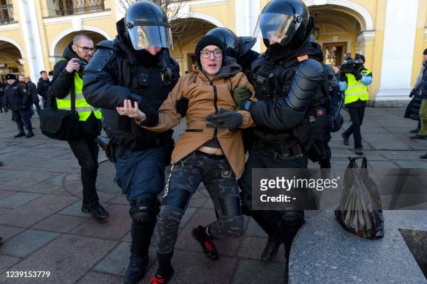 Police officers detain a man during a protest against Russian military action in Ukraine, in central Saint Petersburg on March 13, 2022.