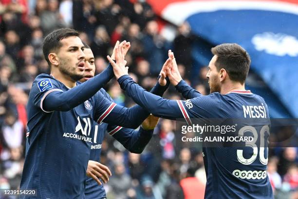 Paris Saint-Germain's Argentinian midfielder Leandro Paredes celebrates with Paris Saint-Germain's Argentinian forward Lionel Messi scoring his...