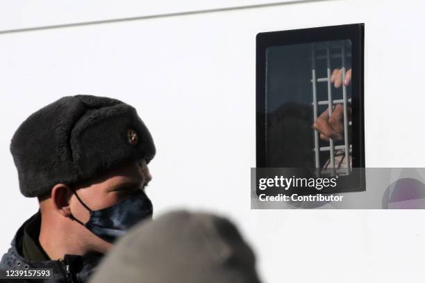 Man detained during a unsanctioned protest rally at Manezhnaya Square in front of the Kremlin, seen inside the paddy wagon, March 2022, in Moscow,...