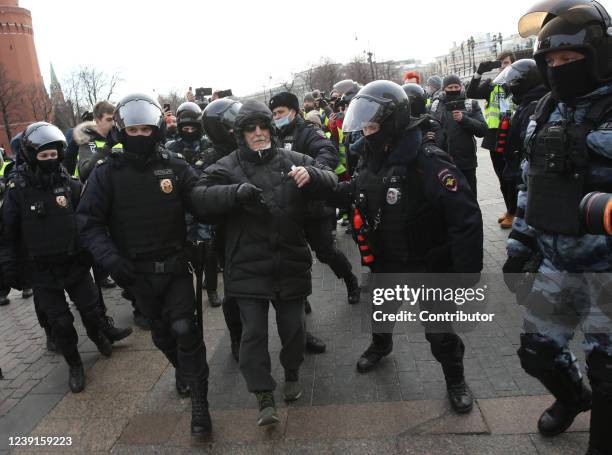 Russian Police officers detain a woman during a unsanctioned protest rally at Manezhnaya Square in front of the Kremlin, March 2022, in Moscow,...