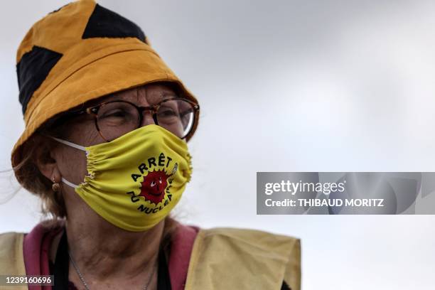 Protester wears a face mask reading "stop to nuclear" during an anti-nuclear protest on March 13, 2022 near the "miroir d'eau" in Bordeaux,...