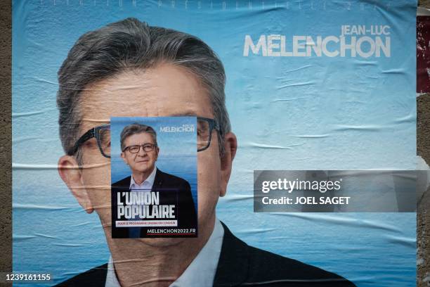 This picture taken on March 13, 2022 in Paris shows a campaign poster of France's leftist movement La France Insoumise candidate for the 2022...