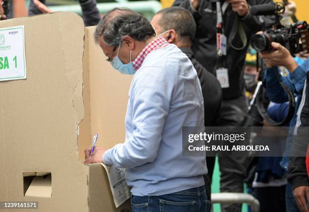 Colombian presidential pre-candidate for the 'Colombia Humana' political party and Historic Pact Coalition, Gustavo Petro, votes at a polling station...