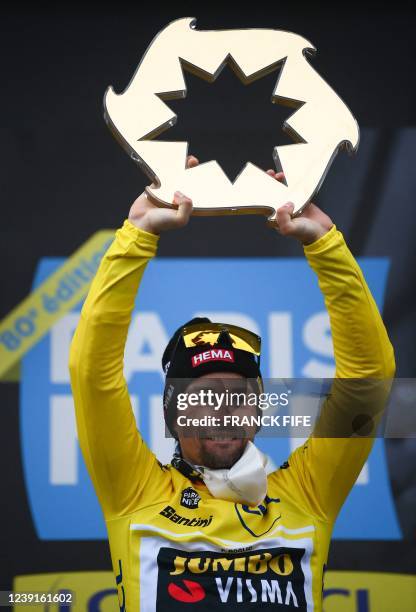 Jumbo-Visma's Slovenian rider Primoz Roglic celebrates his victory with his trophy at the end of the 8th stage of the 80th Paris - Nice cycling race,...