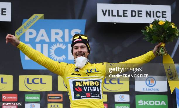 Stage winner Jumbo-Visma's Slovenian rider Primoz Roglic celebrates on the podium his overall leader's yellow jersey at the end of the 8th stage of...