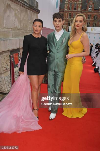 Florence Pugh, Max Harwood and Laura Whitmore attend the EE British Academy Film Awards 2022 at Royal Albert Hall on March 13, 2022 in London,...