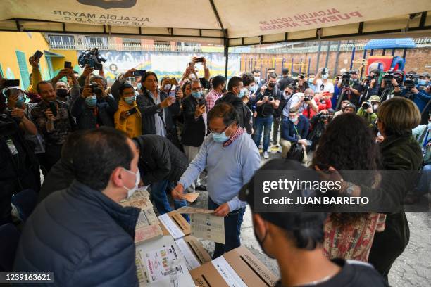 Colombian presidential pre-candidate for the 'Colombia Humana' political party and Historic Pact Coalition, Gustavo Petro, votes at a polling station...