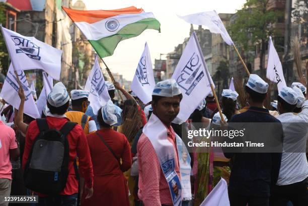 Aam Aadmi Party supporters carry brooms, flags and banners during a 'Padarpan Yatra' rally, to celebrate the partys victory in Punjab Assembly...