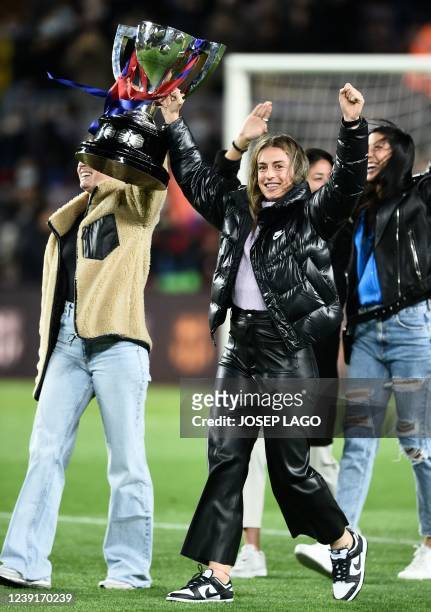 Barcelona's Alexia Putellas holds up a trophy as she celebrates with teammates their Spanish Liga title, before the start of the Spanish league...